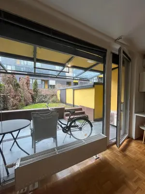 a bike is parked on the balcony of a building at Oasis Atrium Apartment with free parking in Ljubljana