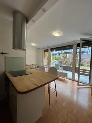 a kitchen with a wooden counter top in a room at Oasis Atrium Apartment with free parking in Ljubljana