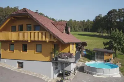 a house with a swimming pool in front of it at Snoopy House in Žužemberk