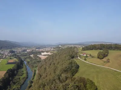 an aerial view of a river and a town at Snoopy House in Žužemberk