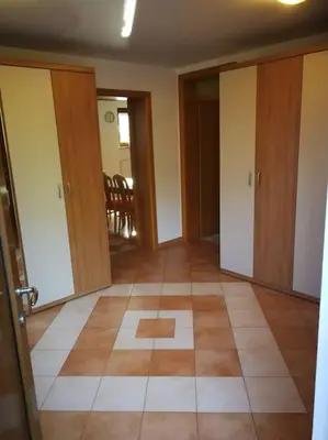 an empty room with doors and a tile floor at Snoopy House in Žužemberk