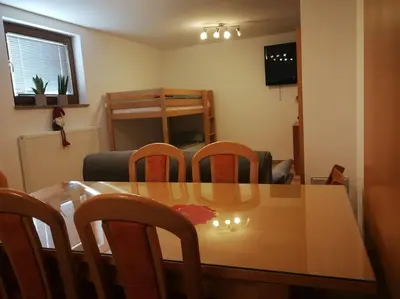 a dining room with a wooden table and chairs at Snoopy House in Žužemberk