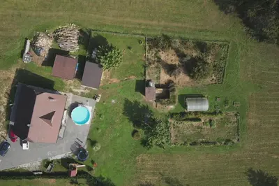 an aerial view of an old house with a pool at Snoopy House in Žužemberk