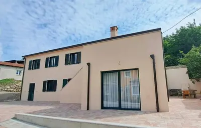 a large white building with a large door at Apartment MoiRai in Gračišče