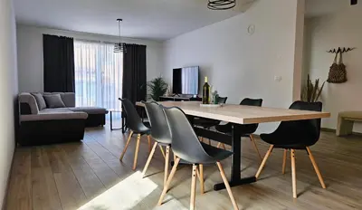 a living room with a dining room table and chairs at Apartment MoiRai in Gračišče