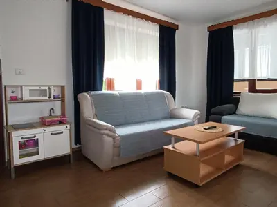a living room with a couch and a table at Apartma Mihatovi in Pivka