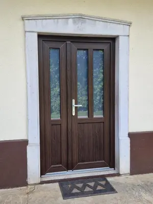 a wooden door on the side of a building at Apartma Mihatovi in Pivka