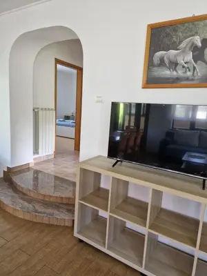 a living room with a television on a table at Apartma Mihatovi in Pivka