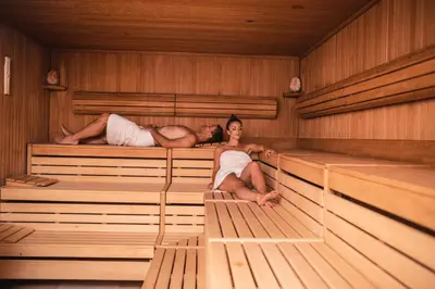 a man and a woman sitting in a sauna at Apartma Marija - Terme Dobrna in Dobrna