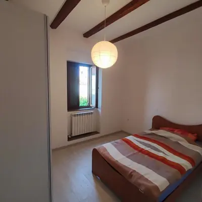 a bedroom with a bed and a window at Casa Rosmarin in Spodnje Škofije