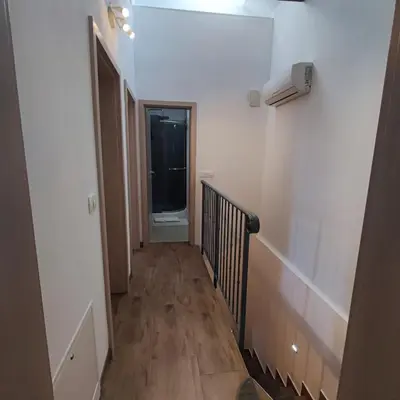a hallway with a stairway with a window at Casa Rosmarin in Spodnje Škofije