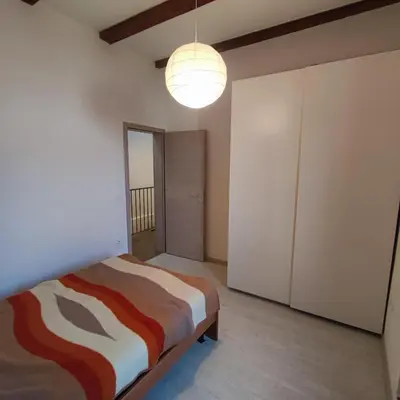 a bedroom with a bed and a light at Casa Rosmarin in Spodnje Škofije