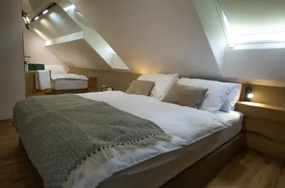 a bedroom with a large white bed with a window at Hiša TRELC- sobe in Komenda