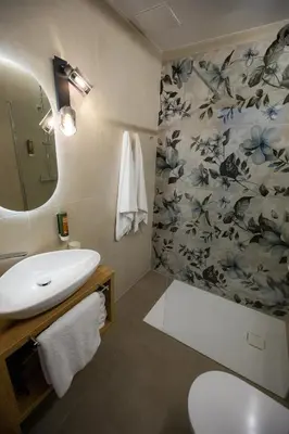 a bathroom with a sink and a toilet and a mirror at Hiša TRELC- sobe in Komenda