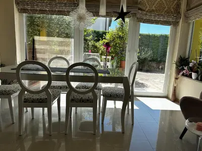 a dining room with a table and chairs and a window at Apartment HOME SWEET HOME in Zgornje Škofije