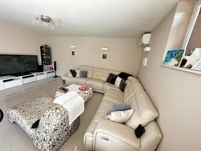 a living room with a couch and a flat screen tv at Apartment HOME SWEET HOME in Zgornje Škofije