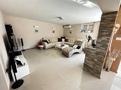 a living room with a couch and a table at Apartment HOME SWEET HOME in Zgornje Škofije