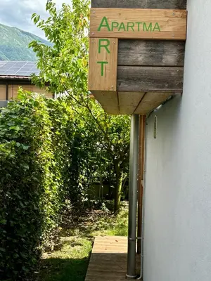 a wooden sign that saysarma on the side of a building at Apartma ART in Kobarid