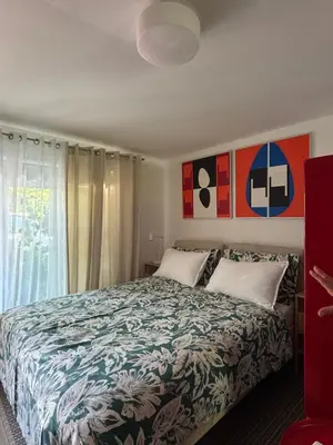a bedroom with a large bed and a window at Apartma ART in Kobarid