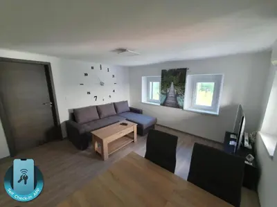 a living room with a couch and a table at Apartment Ledince in Most na Soči