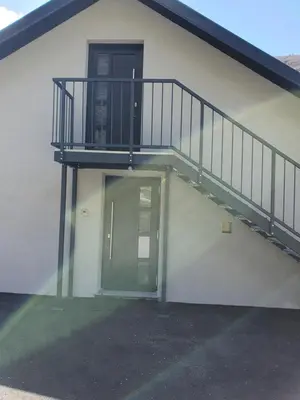 a building with a staircase next to a door at Apartment Ledince in Most na Soči