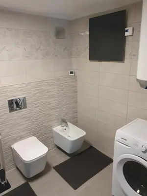 a bathroom with a toilet and a bidet and a sink at Apartment Ledince in Most na Soči