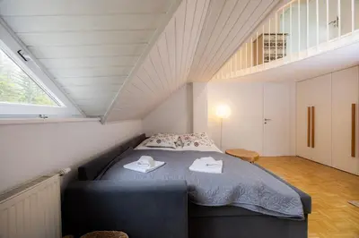 a bedroom with a bed with two towels on it at Apartma Pehta in Kranjska Gora