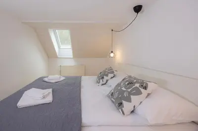 a bedroom with a bed with a napkin on it at Apartma Pehta in Kranjska Gora