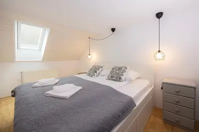 a bedroom with a bed with two towels on it at Apartma Pehta in Kranjska Gora