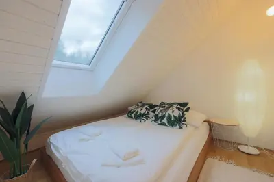 a small bedroom with a bed in a attic at Apartma Pehta in Kranjska Gora