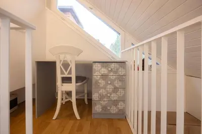 a white staircase with a stool in a room at Apartma Pehta in Kranjska Gora
