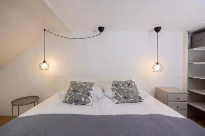 a bedroom with a white bed with two pillows at Apartma Pehta in Kranjska Gora