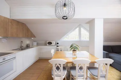 a kitchen and dining room with a table and chairs at Apartma Pehta in Kranjska Gora