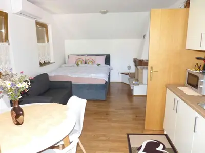 a small living room with a bed and a table at Holiday home in Dragatus - Kranjska (Krain) 50798 in Dragatuš