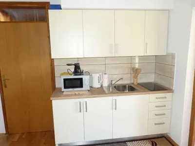 a small kitchen with a sink and a microwave at Holiday home in Dragatus - Kranjska (Krain) 50798 in Dragatuš