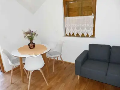 a living room with a table and a couch at Holiday home in Dragatus - Kranjska (Krain) 50798 in Dragatuš