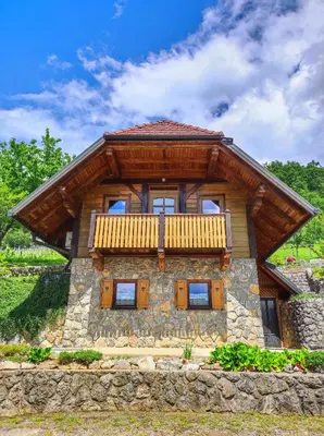 a log home with a balcony on top of it at Vineyard cottage Kralj in Uršna Sela