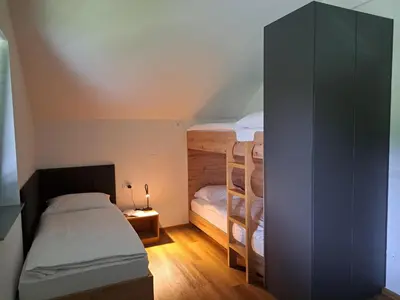 a bedroom with two bunk beds in a attic at S&B's RETREAT in Godovič