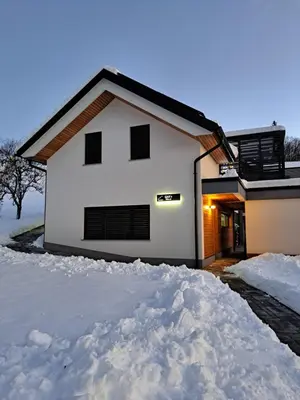 a white house with a lot of snow around it at S&B's RETREAT in Godovič