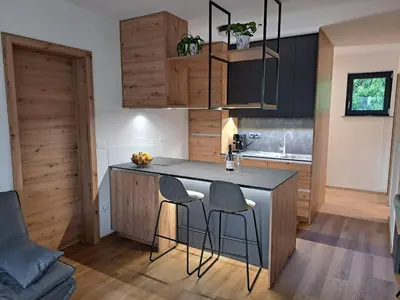 a kitchen with a counter and stools in a room at S&B's RETREAT in Godovič