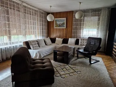 a living room with a couch and a chair at GreenFamilyAppartment near Ljubljana in Domžale