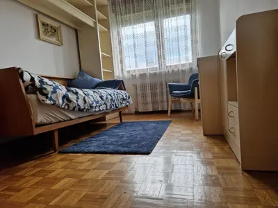 a living room with a couch and a window at GreenFamilyAppartment near Ljubljana in Domžale