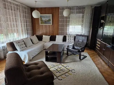 a living room with a couch and a chair at GreenFamilyAppartment near Ljubljana in Domžale
