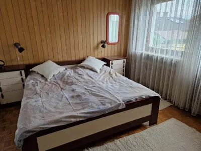a bedroom with a bed and a window at GreenFamilyAppartment near Ljubljana in Domžale
