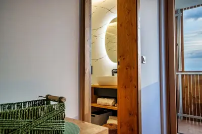a bathroom with a sink and a mirror at Tourist Farm HOTEL FROST in Maribor
