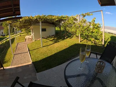 a table with a glass of wine on a patio at Slivnisko Jezero Hisa in Veliki Rakitovec
