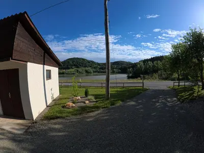 a road next to a building with a fence at Slivnisko Jezero Hisa in Veliki Rakitovec