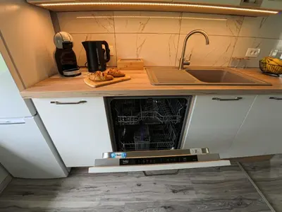 a small kitchen with a sink and an oven at Slivnisko Jezero Hisa in Veliki Rakitovec