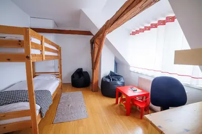 a bedroom with a bunk bed and a desk at Hiša na Dovjem in Mojstrana