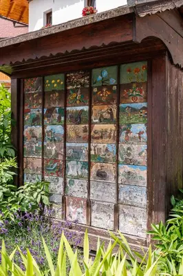 a wall with many different paintings on it at Hiša na Dovjem in Mojstrana